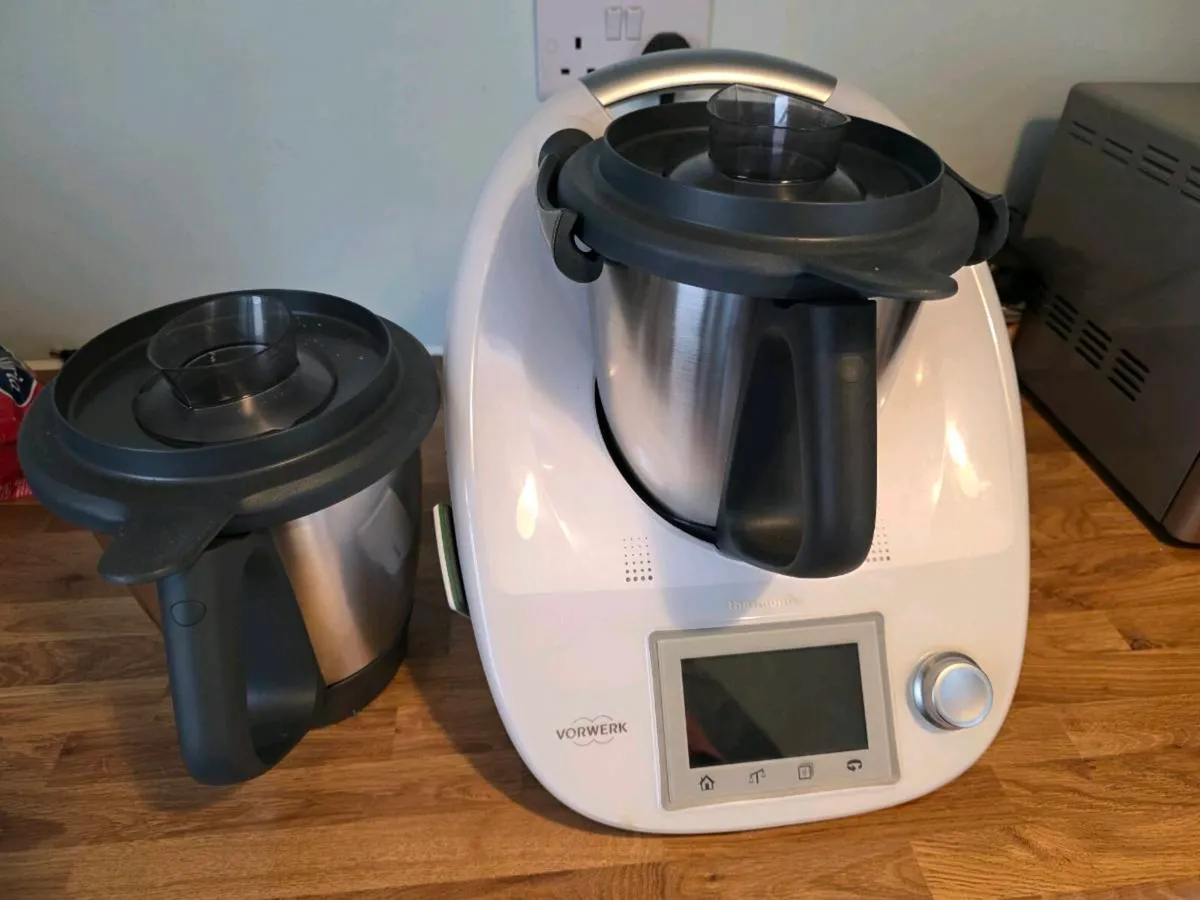 A Thermomix and spare mixing bowl on a kitchen counter